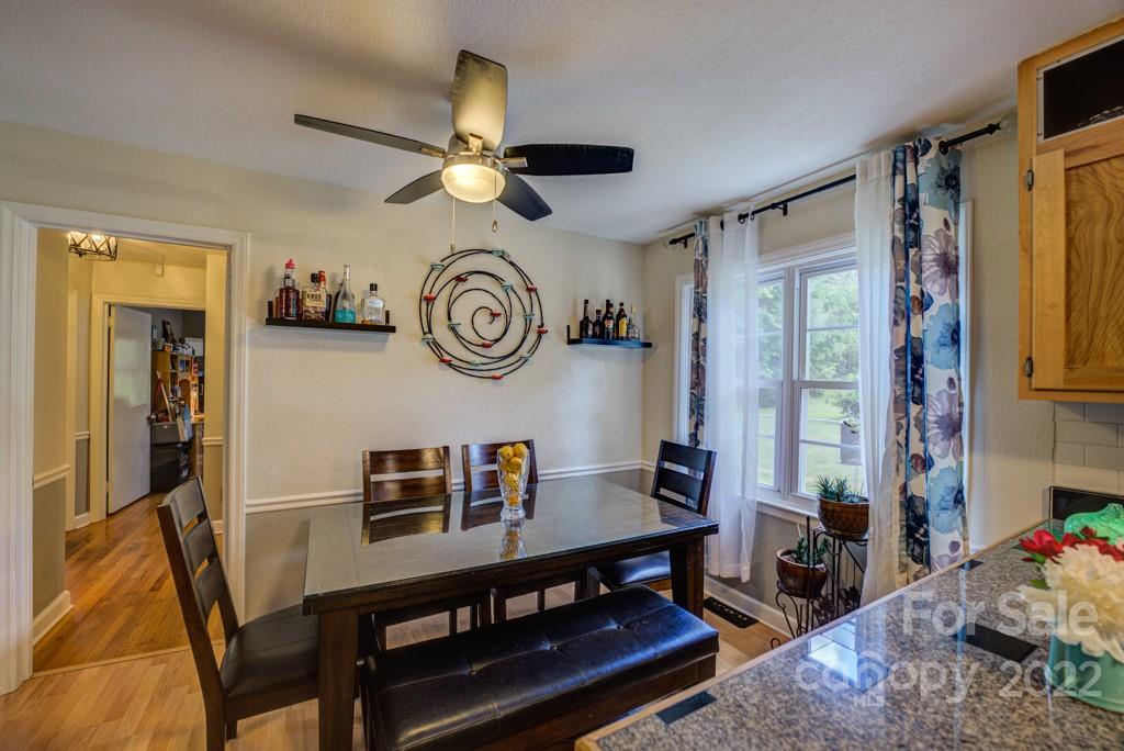 292 Brookside Camp Road Hendersonville, NC 28792 - Photo 7 of 41 a view of a dining room with furniture and a large window