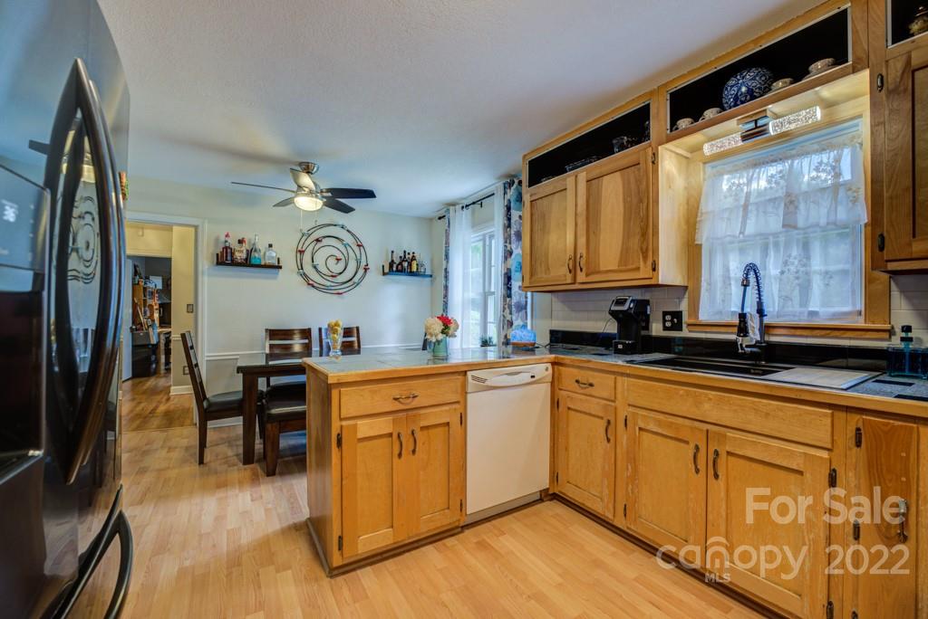292 Brookside Camp Road Hendersonville, NC 28792 - Photo 9 of 41 a large kitchen with cabinets a sink and stainless steel appliances