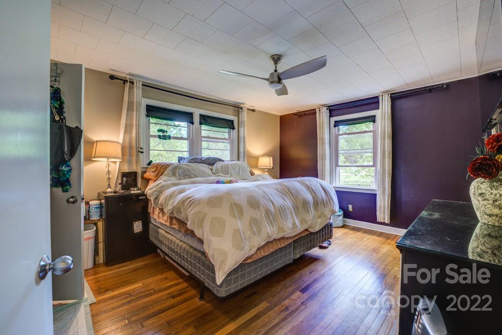 292 Brookside Camp Road Hendersonville, NC 28792 - Photo 10 of 41 a bed sitting in a spacious bedroom next to a window