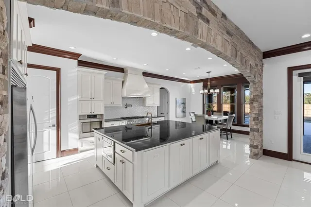 a kitchen with sink and refrigerator