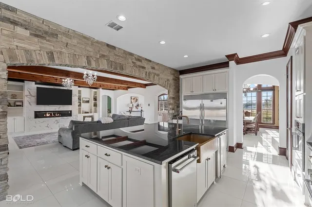 a kitchen with stainless steel appliances granite countertop a sink and cabinets