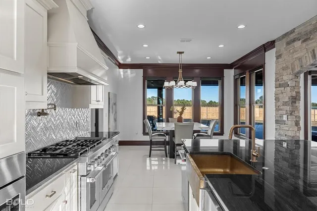 a kitchen with a stove and white cabinets