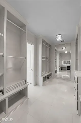 a spacious bedroom with a bed and a table in it