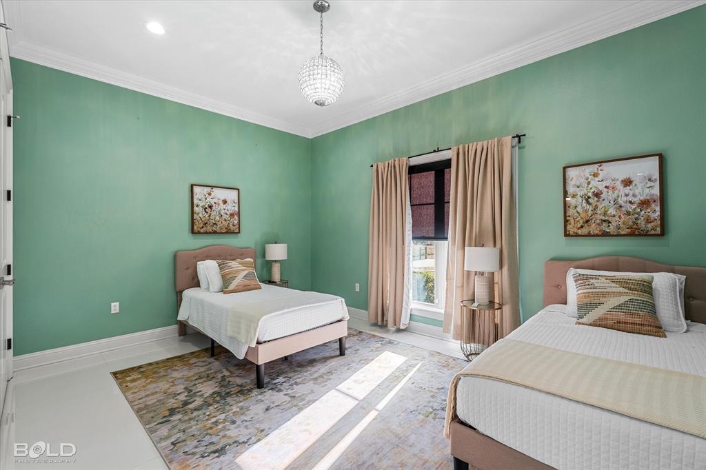 9480 McCain Road Shreveport, LA 71107 - Photo 26 of 40 a bedroom with a bed and a chandelier
