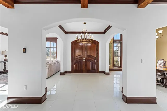 a view of a dining room with furniture chandelier and a chandelier