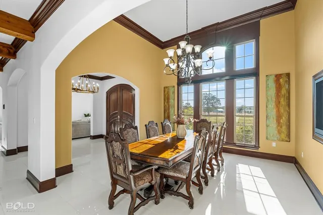 a living room with furniture chandelier and a large window