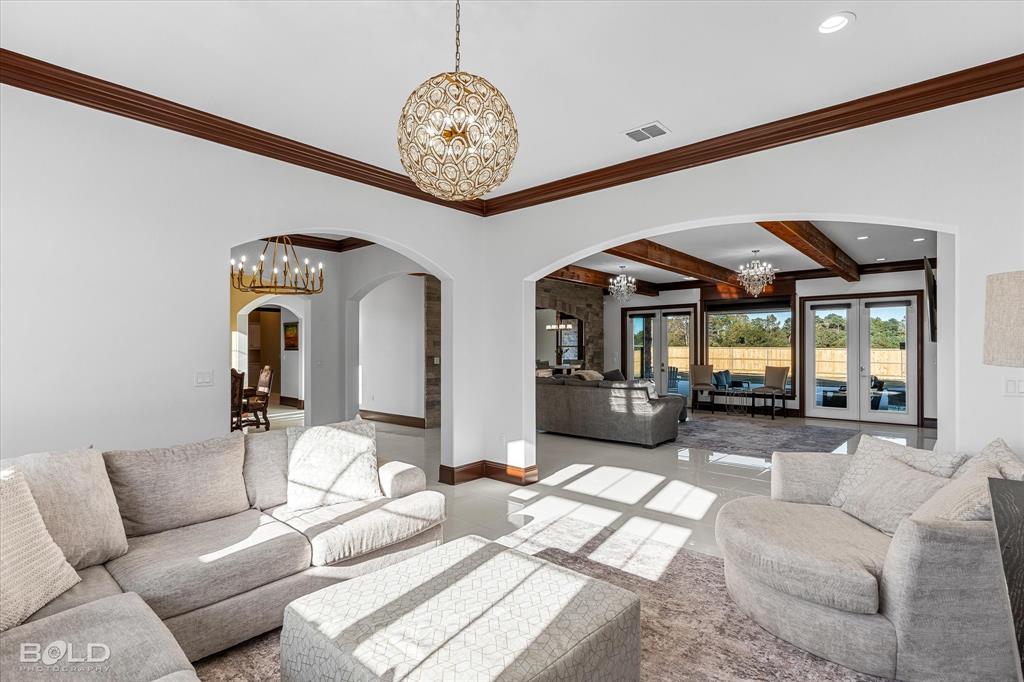9480 McCain Road Shreveport, LA 71107 - Photo 6 of 40 a living room with furniture chandelier and a large window
