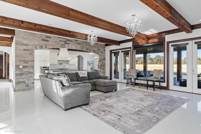 a living room with furniture and a chandelier