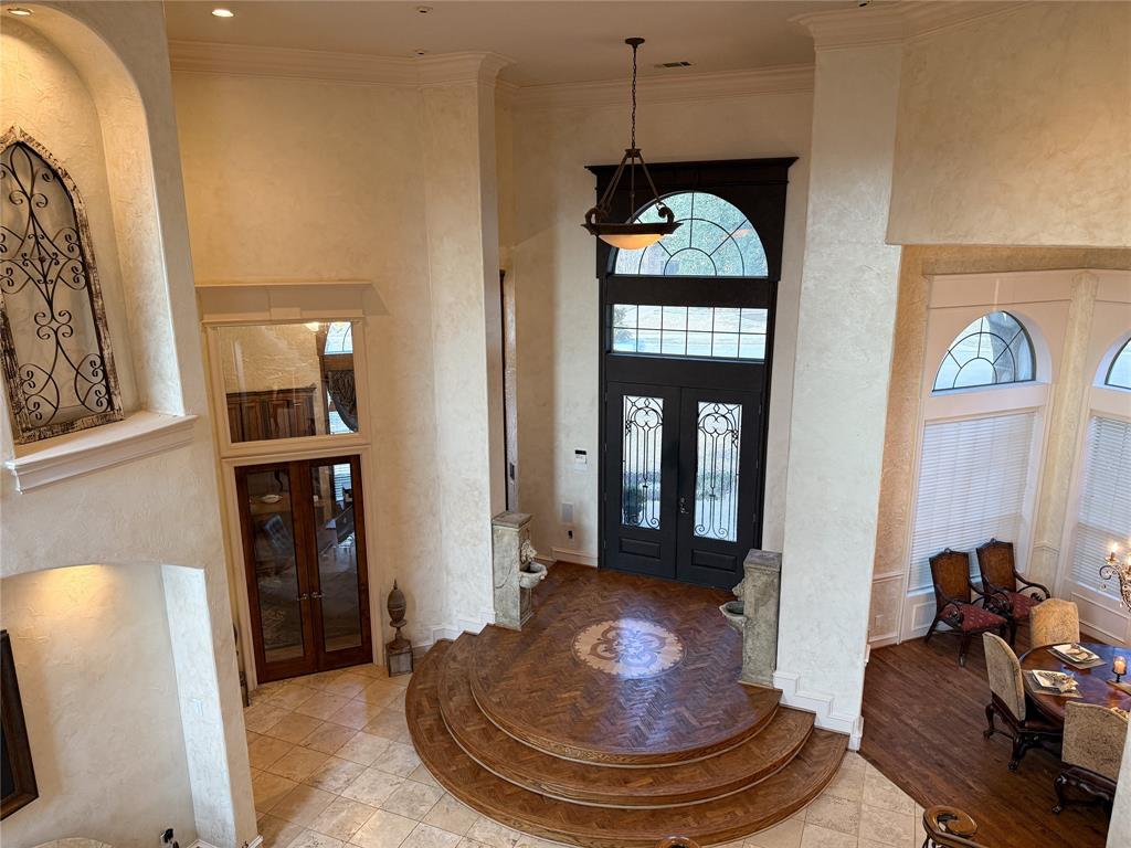 1919 Kings Pass Heath, TX 75032 - Photo 11 of 38 Entryway featuring french doors, a high ceiling, parquet floors, and crown molding