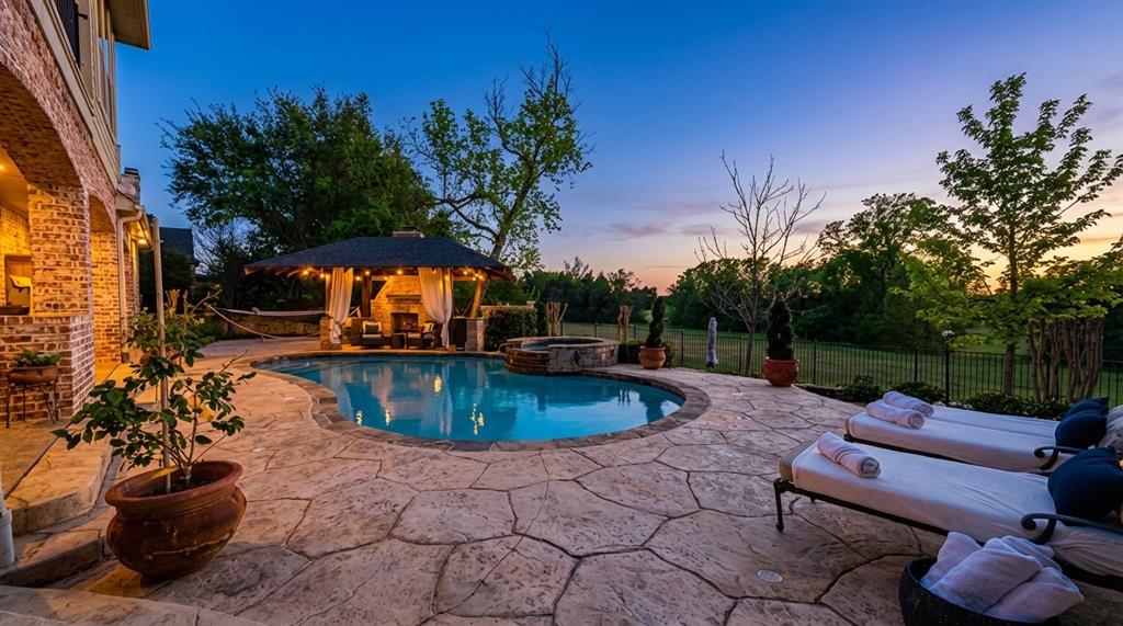 1919 Kings Pass Heath, TX 75032 - Photo 3 of 38 Pool at dusk featuring a patio and a pool with connected hot tub