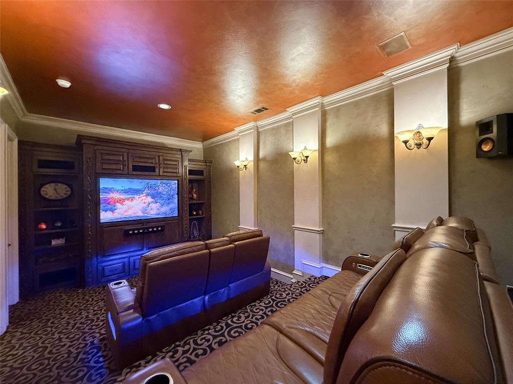 1919 Kings Pass Heath, TX 75032 - Photo 35 of 38 Home theater room featuring crown molding and dark carpet