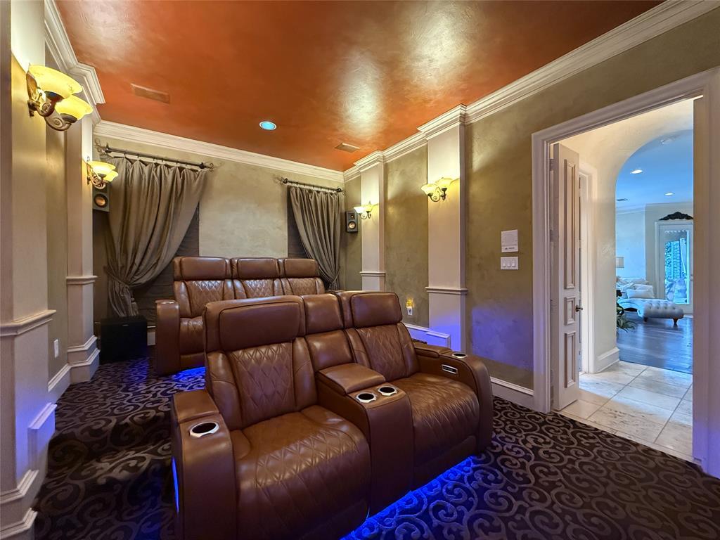 1919 Kings Pass Heath, TX 75032 - Photo 36 of 38 Carpeted home theater with ornamental molding, arched walkways, and recessed lighting