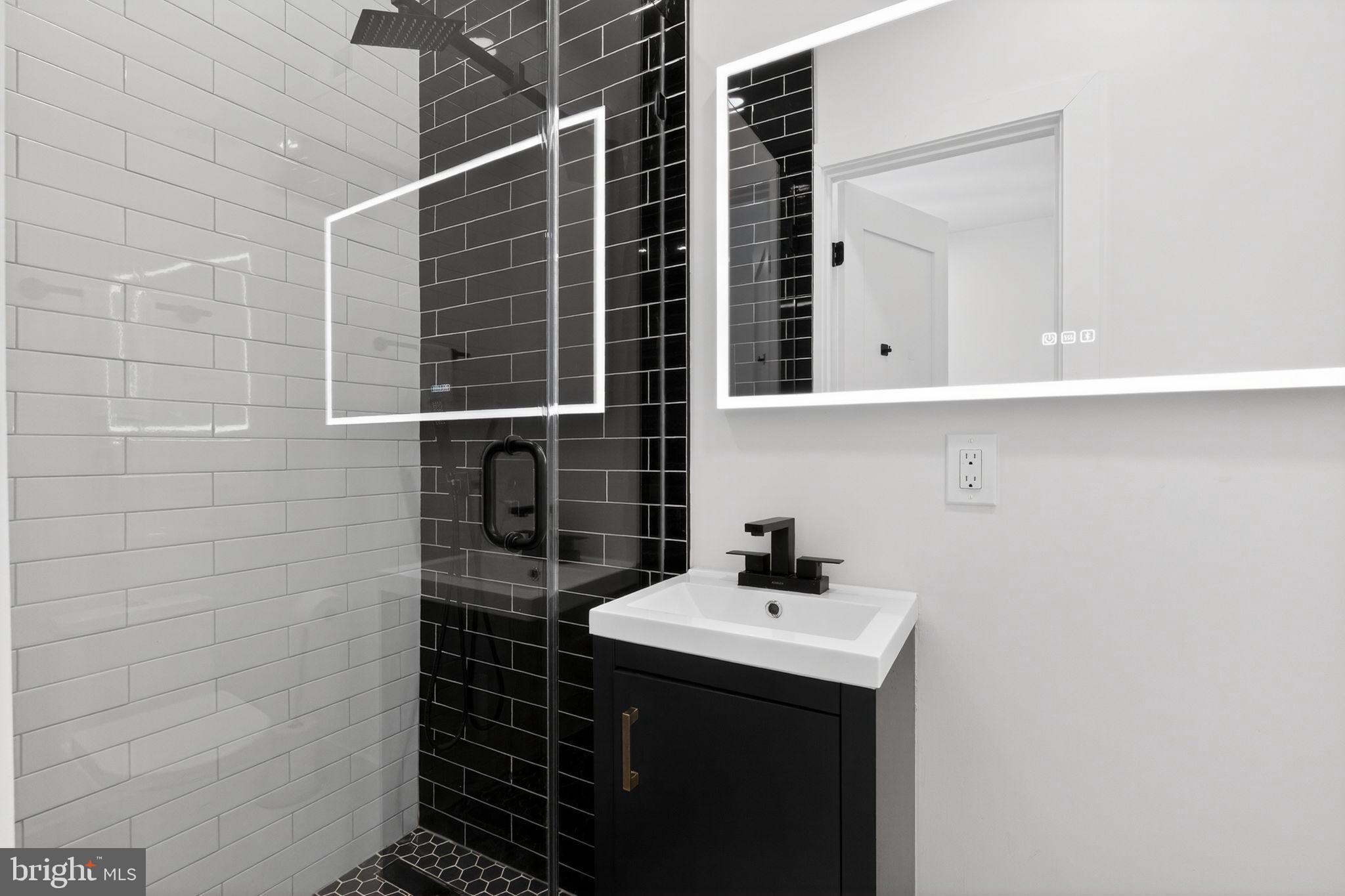 1307 Longfellow Street Northwest, Unit 8 Washington, DC 20011 - Photo 13 of 26 a bathroom with a sink and a mirror