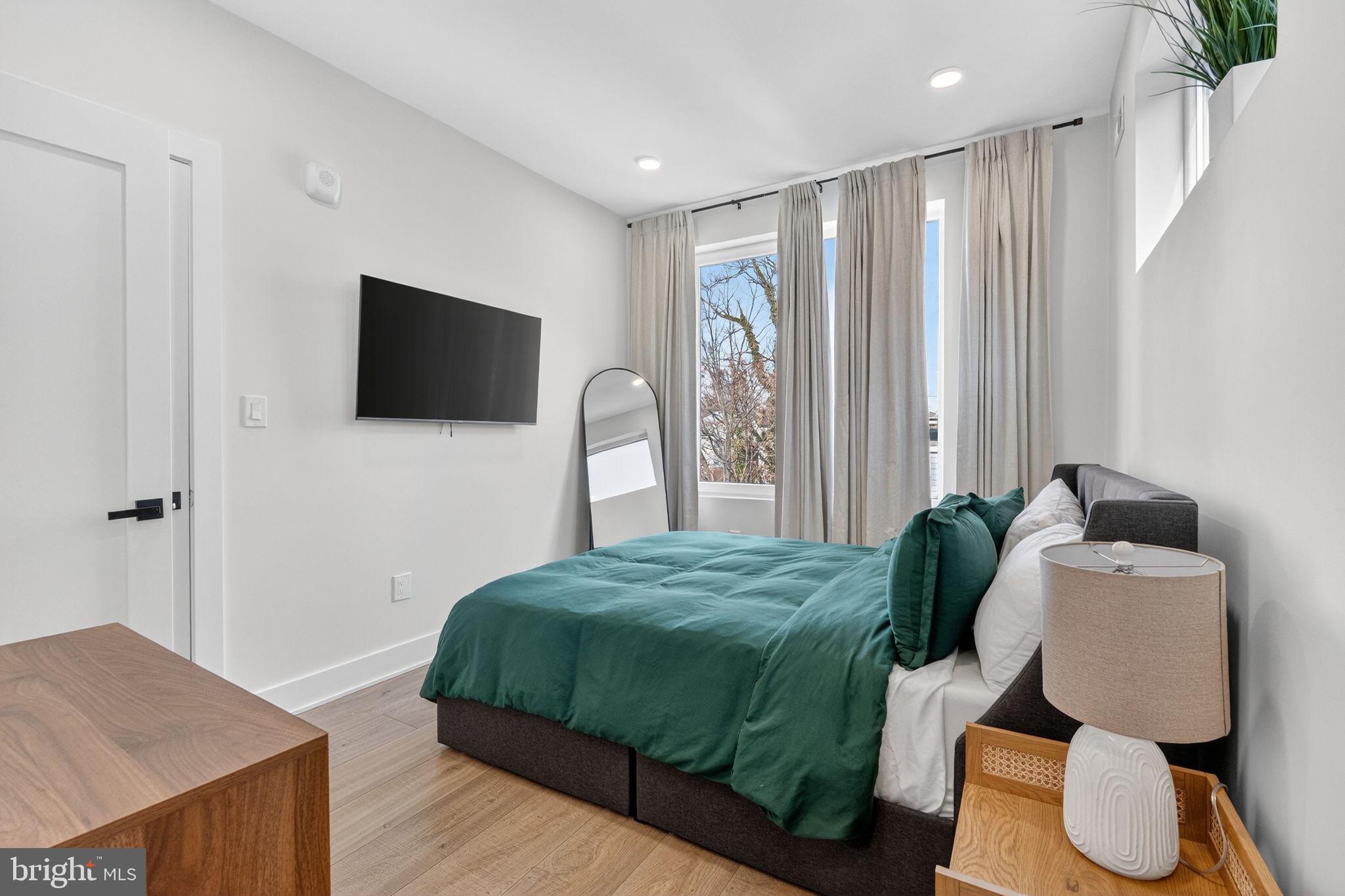 1307 Longfellow Street Northwest, Unit 8 Washington, DC 20011 - Photo 17 of 26 a bedroom with a bed and a television