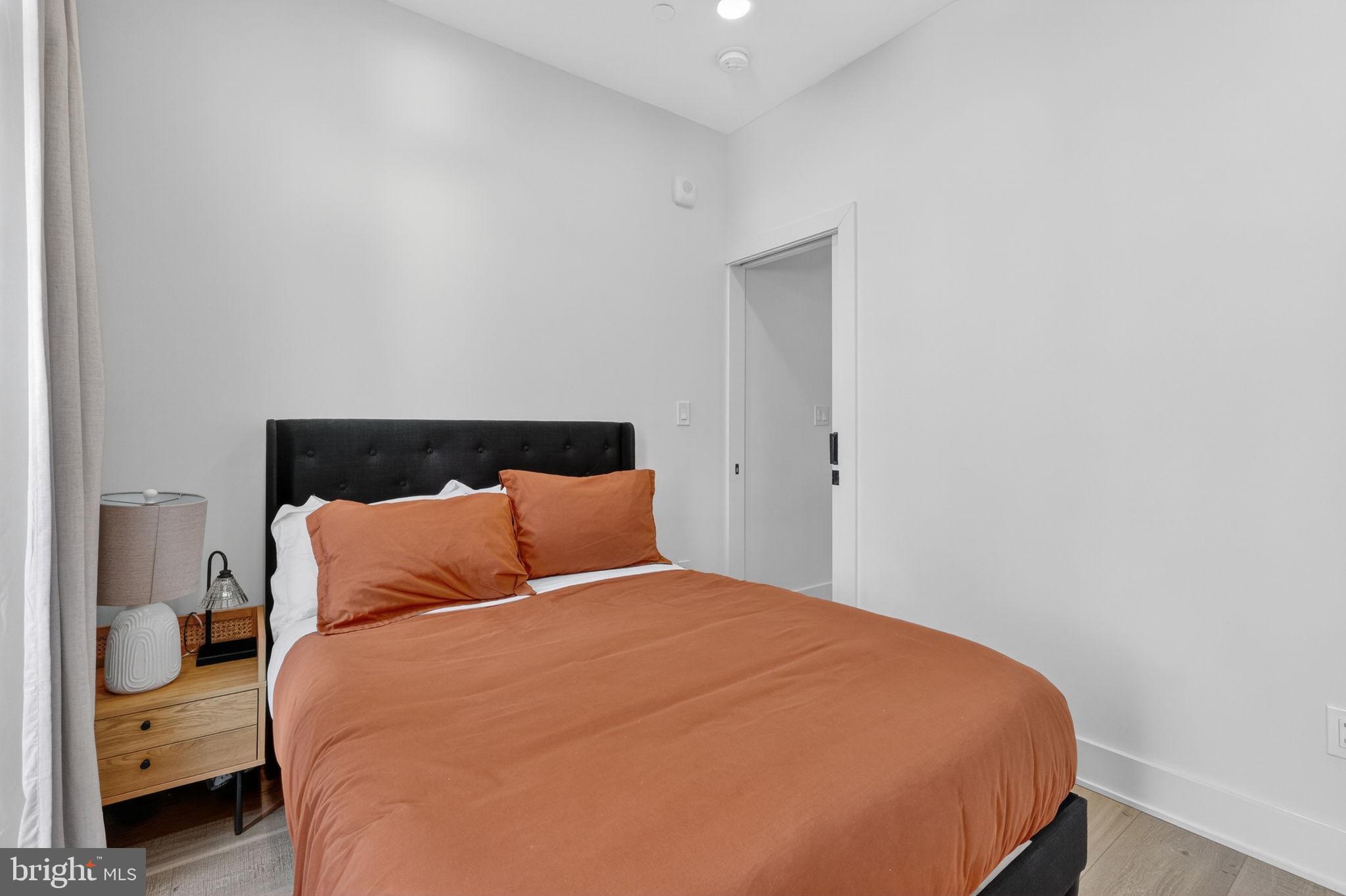 1307 Longfellow Street Northwest, Unit 8 Washington, DC 20011 - Photo 22 of 26 a bedroom with a bed and window