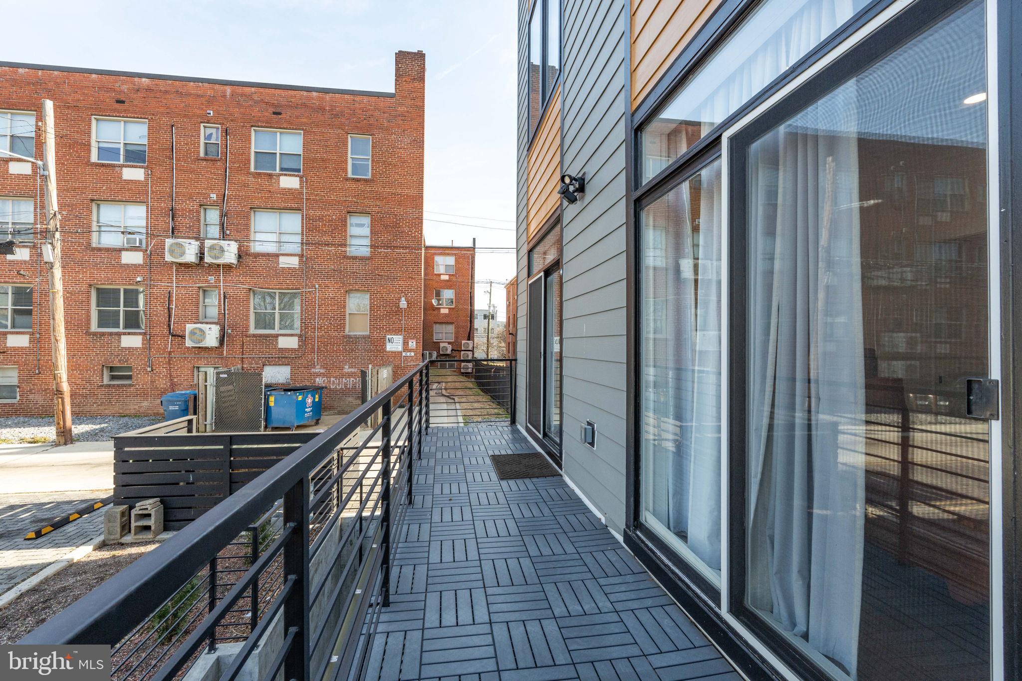 1307 Longfellow Street Northwest, Unit 8 Washington, DC 20011 - Photo 25 of 26 a view of balcony with a couple of cars parked in front of house