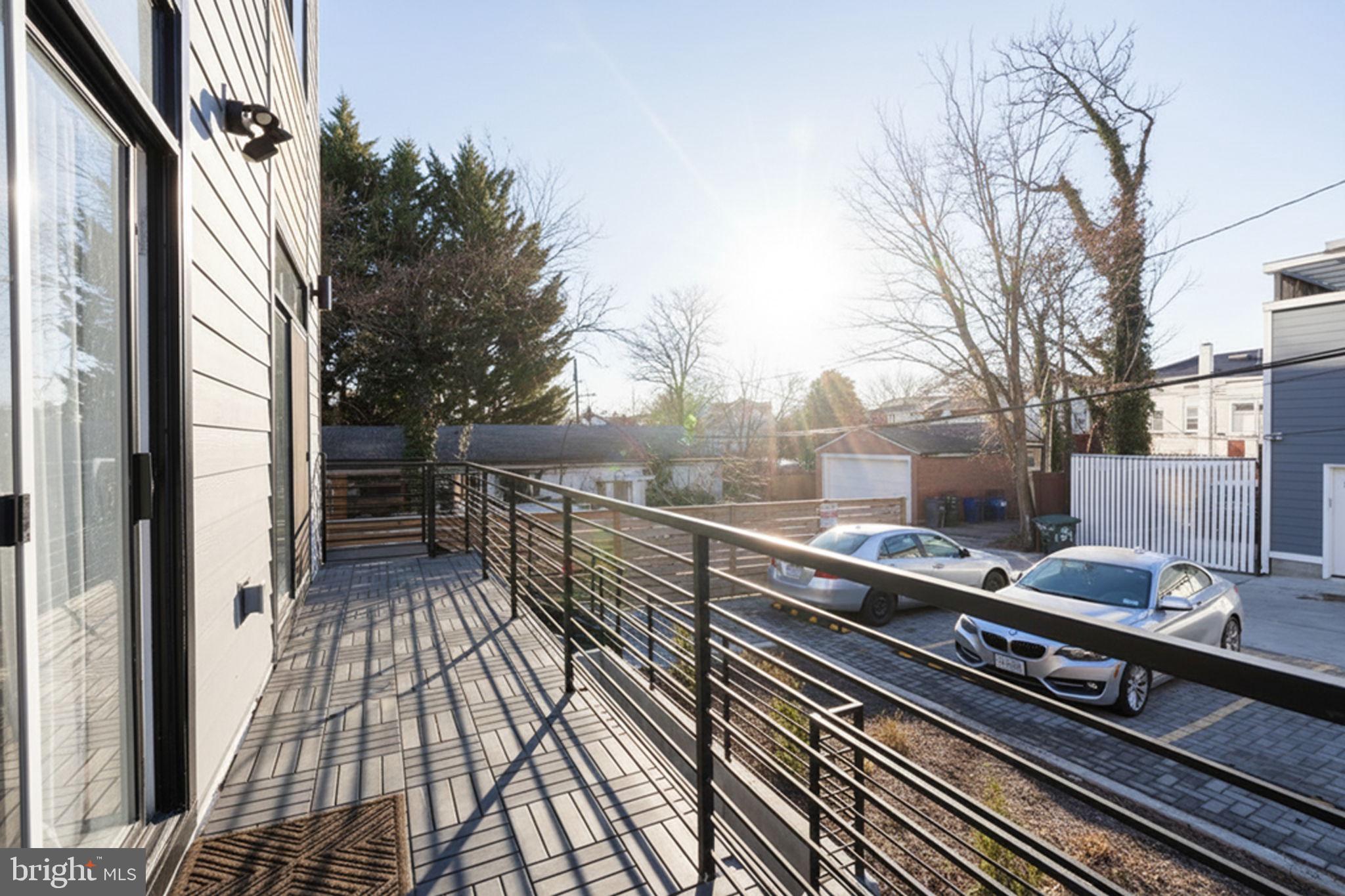 1307 Longfellow Street Northwest, Unit 8 Washington, DC 20011 - Photo 26 of 26 a view of a balcony with wooden floor and fence and a floor to ceiling window