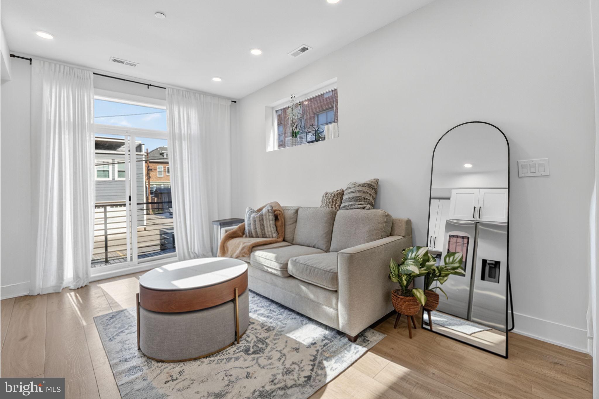 1307 Longfellow Street Northwest, Unit 8 Washington, DC 20011 - Photo 6 of 26 a living room with furniture a window and a potted plant