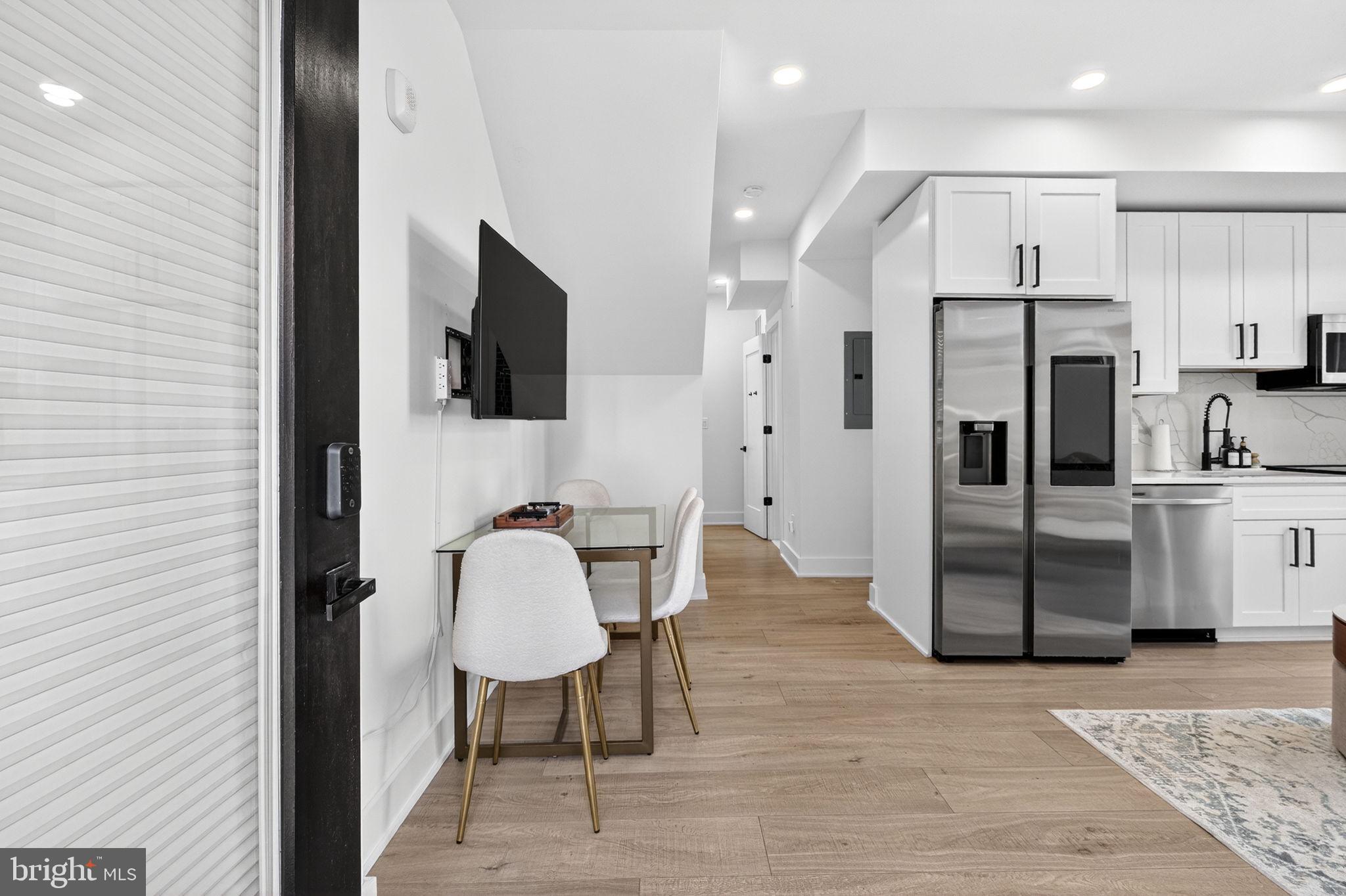 1307 Longfellow Street Northwest, Unit 8 Washington, DC 20011 - Photo 8 of 26 a kitchen with stainless steel appliances granite countertop a refrigerator and a stove top oven