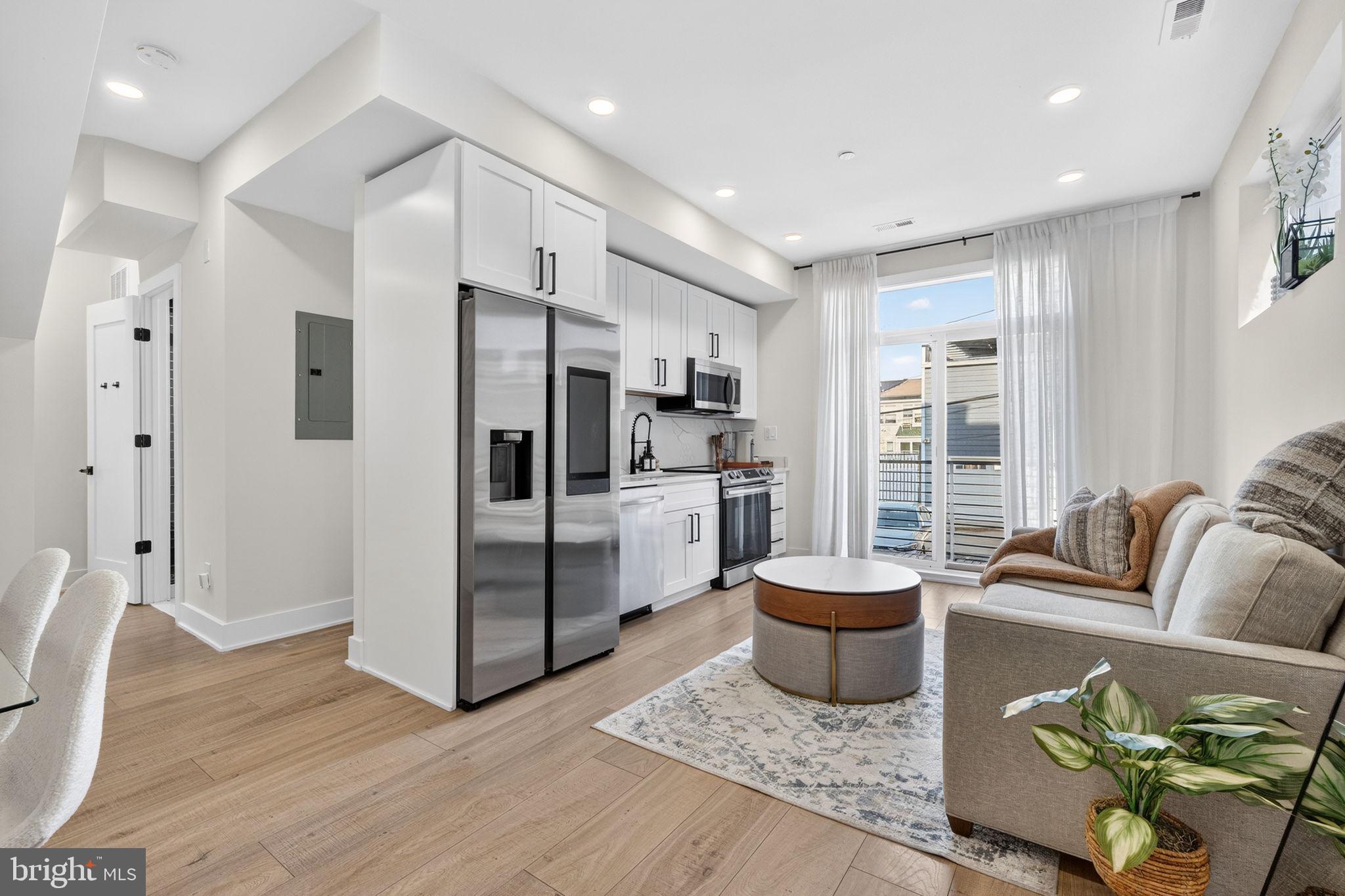 1307 Longfellow Street Northwest, Unit 8 Washington, DC 20011 - Photo 9 of 26 a large living room with stainless steel appliances granite countertop furniture and a rug