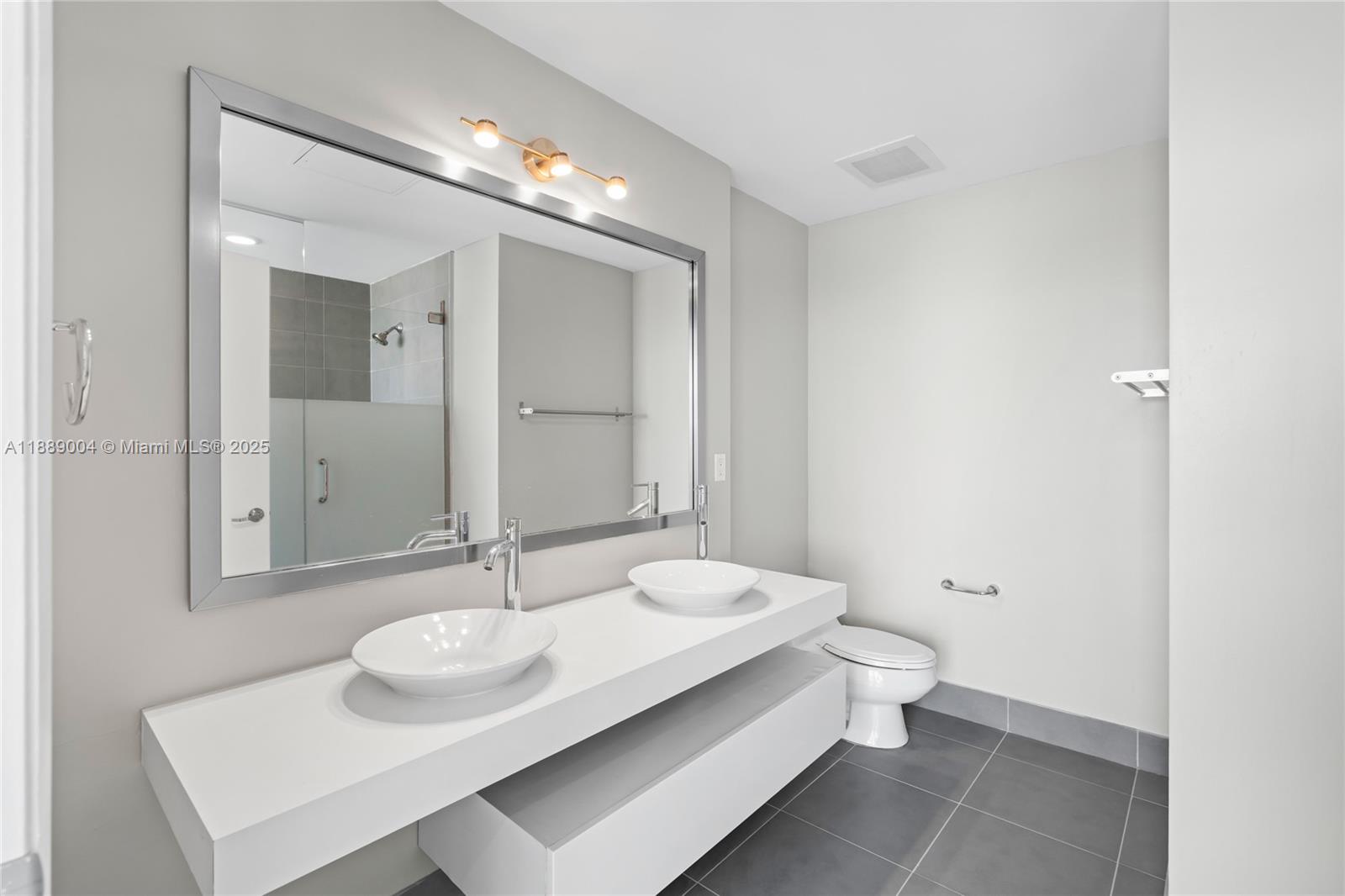 92 Southwest 3rd Street, Unit 5206 Miami, FL 33130 - Photo 16 of 21 a bathroom with a sink and a mirror