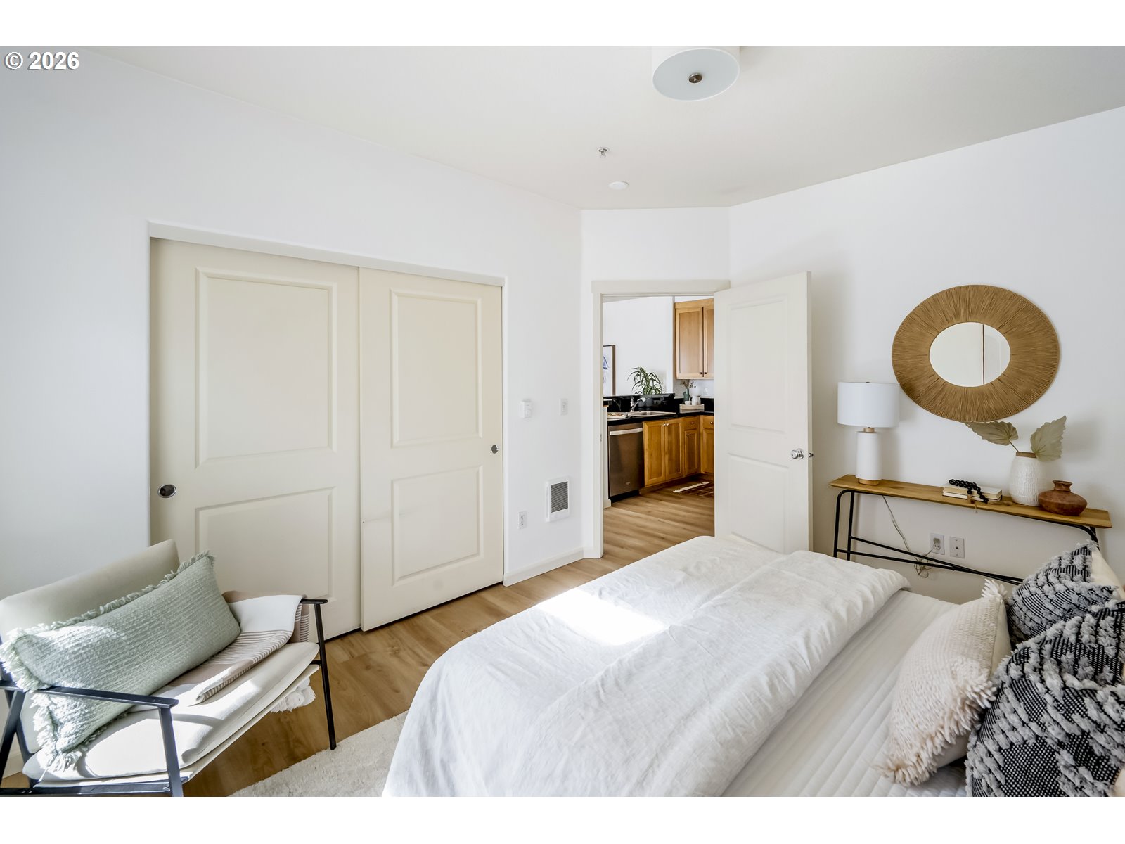 1100 Southwest 170th Avenue, Unit 100 Beaverton, OR 97003 - Photo 11 of 17 a bedroom with a bed a mirror and a chair