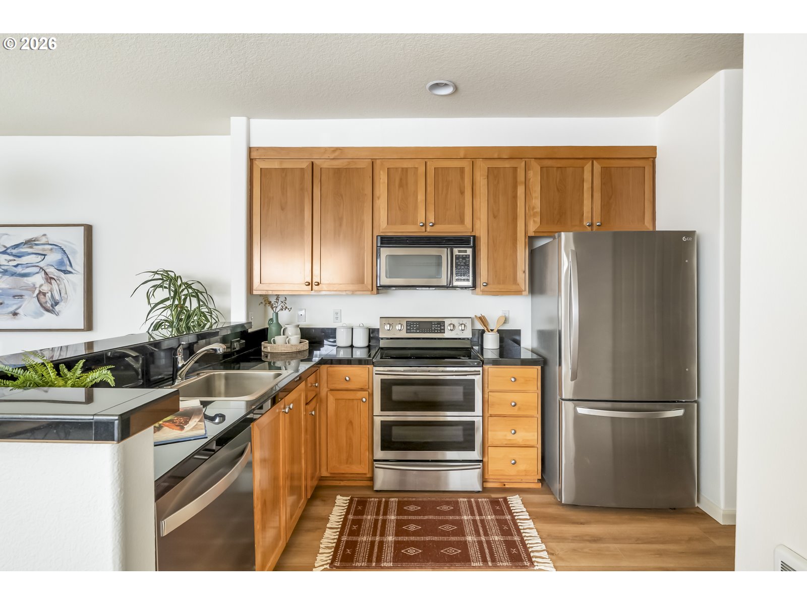 1100 Southwest 170th Avenue, Unit 100 Beaverton, OR 97003 - Photo 8 of 17 a kitchen with granite countertop a refrigerator and a sink