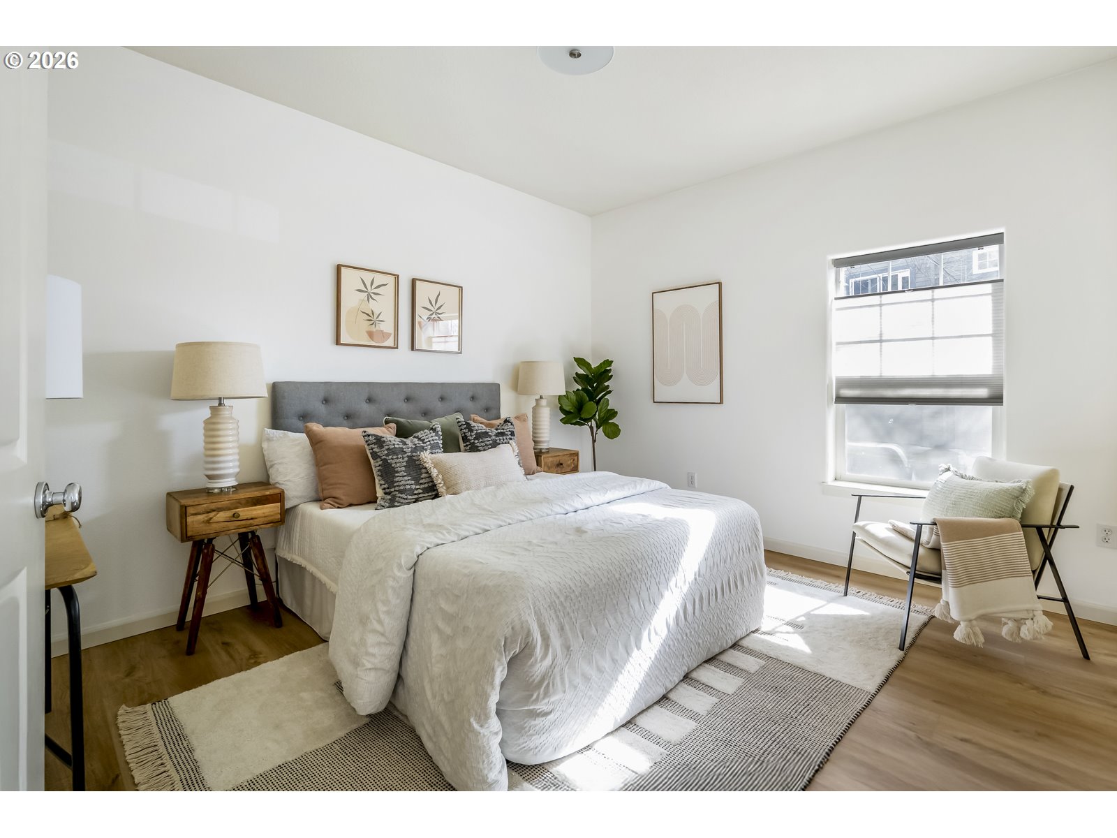 1100 Southwest 170th Avenue, Unit 100 Beaverton, OR 97003 - Photo 10 of 17 a bedroom with a bed a table and chair