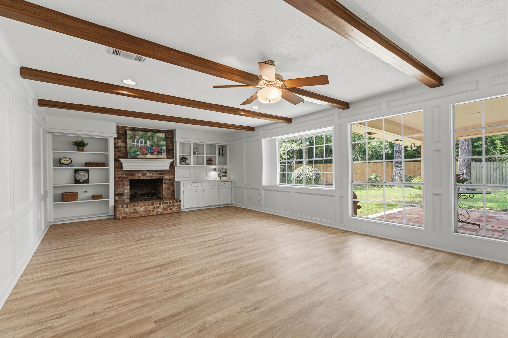 3422 Candlewisp Drive Spring, TX 77388 - Photo 8 of 50 FAMILY ROOM - Large windows along the back of the home provide great views of the spacious back yard. Notice the wood beams in the ceiling, and the built-in shelves and cabinets on either side of the fireplace.