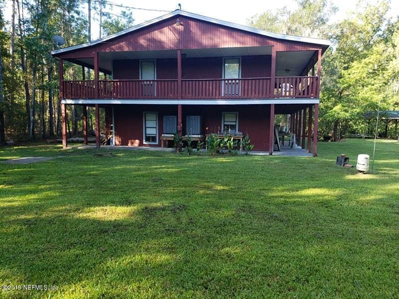 419 Marina Road Satsuma, FL 32189 - Photo 1 of 18 a view of a cafe with a big yard and potted plants