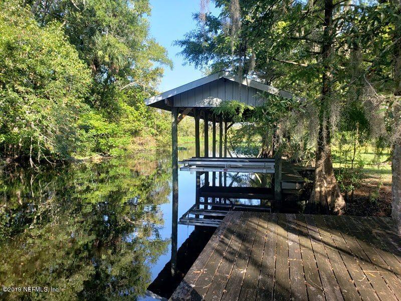419 Marina Road Satsuma, FL 32189 - Photo 2 of 18 a view of a wooden bench sitting under a large tree
