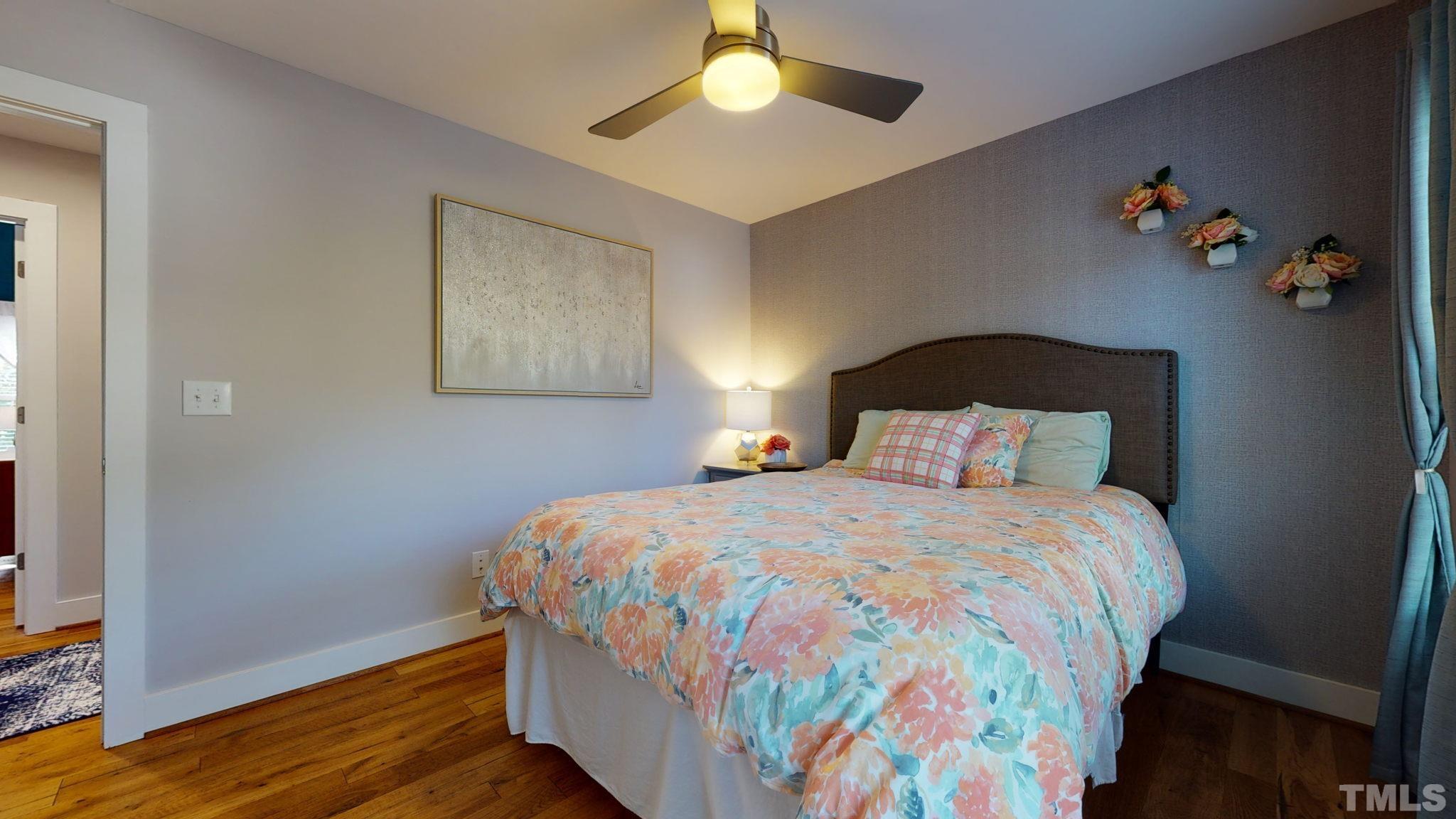 514 Freeman Street Raleigh, NC 27601 - Photo 14 of 27 a bedroom with a bed and a chandelier