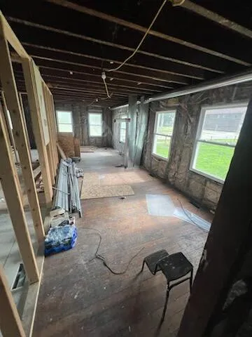 a view of a room with wooden floor and windows