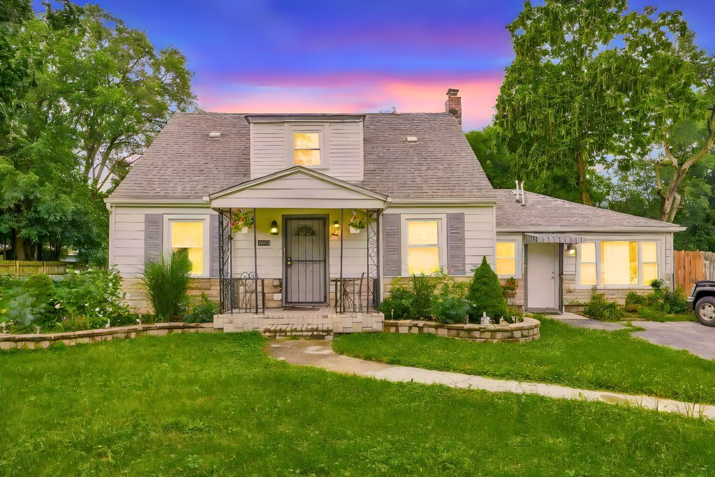 a front view of a house with a yard table and chairs