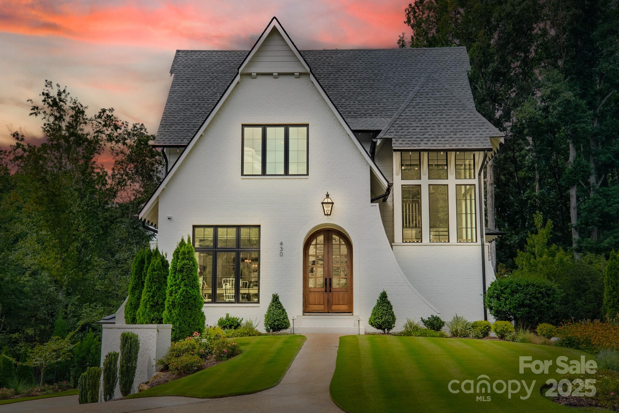 a front view of a house with garden