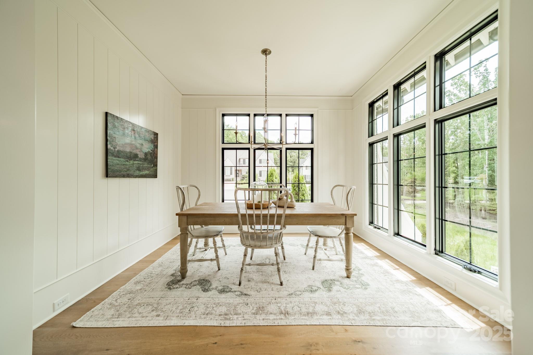 430 Bramble Way Fort Mill, SC 29708 - Photo 11 of 45 a view of a dining room with furniture wooden floor and a chandelier