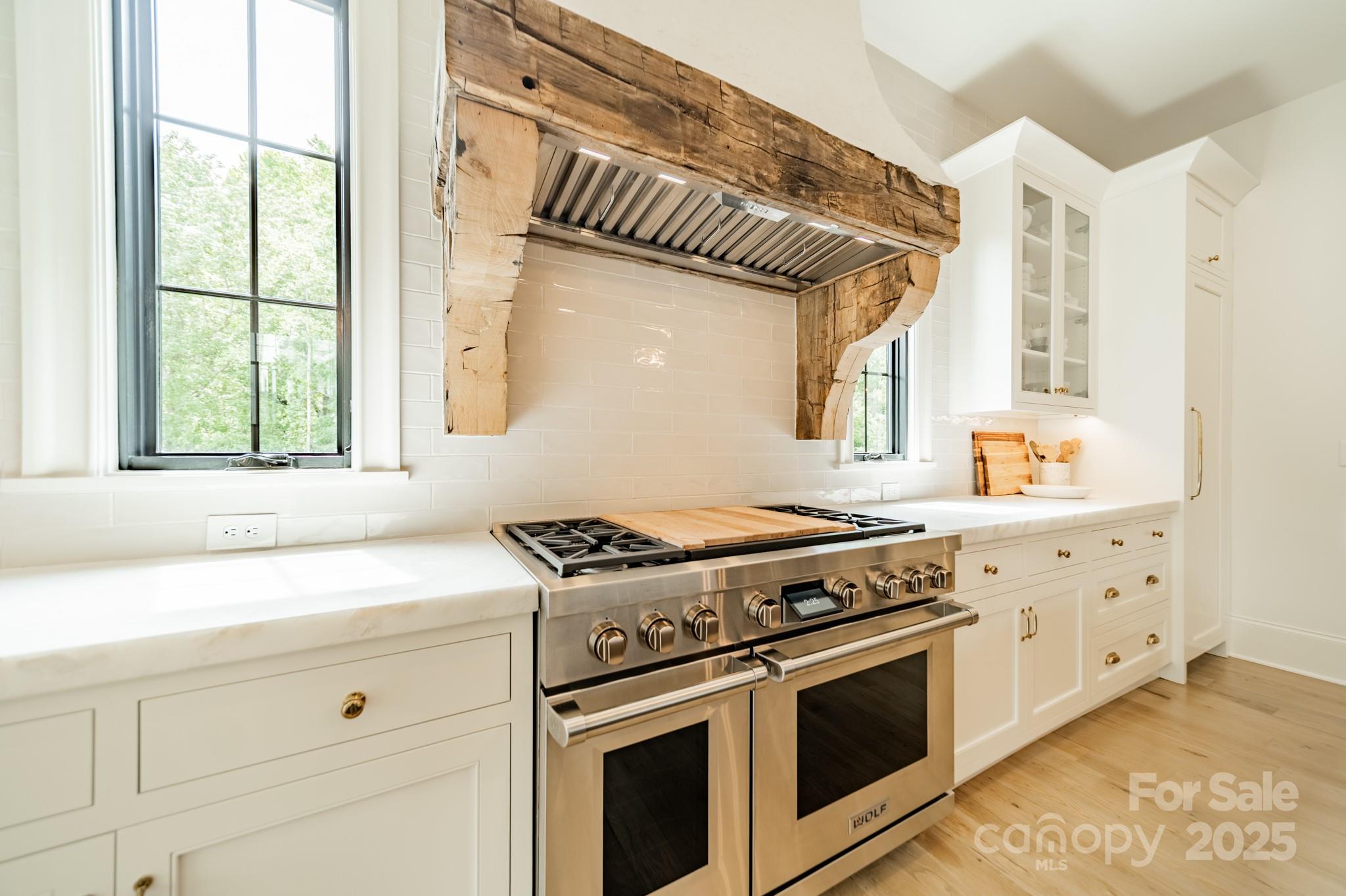 430 Bramble Way Fort Mill, SC 29708 - Photo 5 of 45 a kitchen with granite countertop a stove a sink and dishwasher with white cabinets