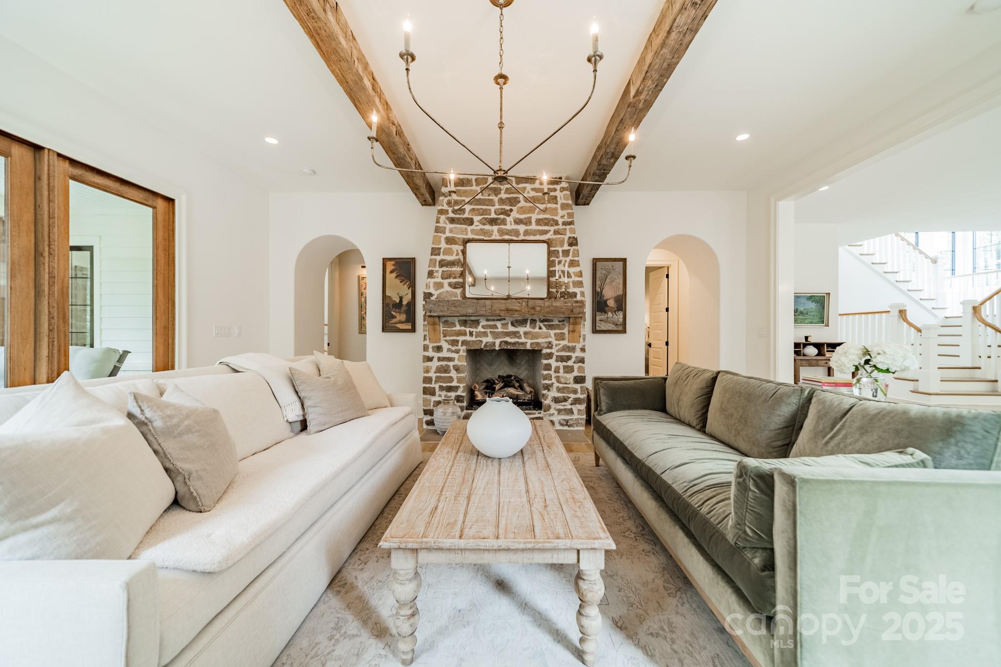 430 Bramble Way Fort Mill, SC 29708 - Photo 8 of 45 a living room with furniture a fireplace and a chandelier