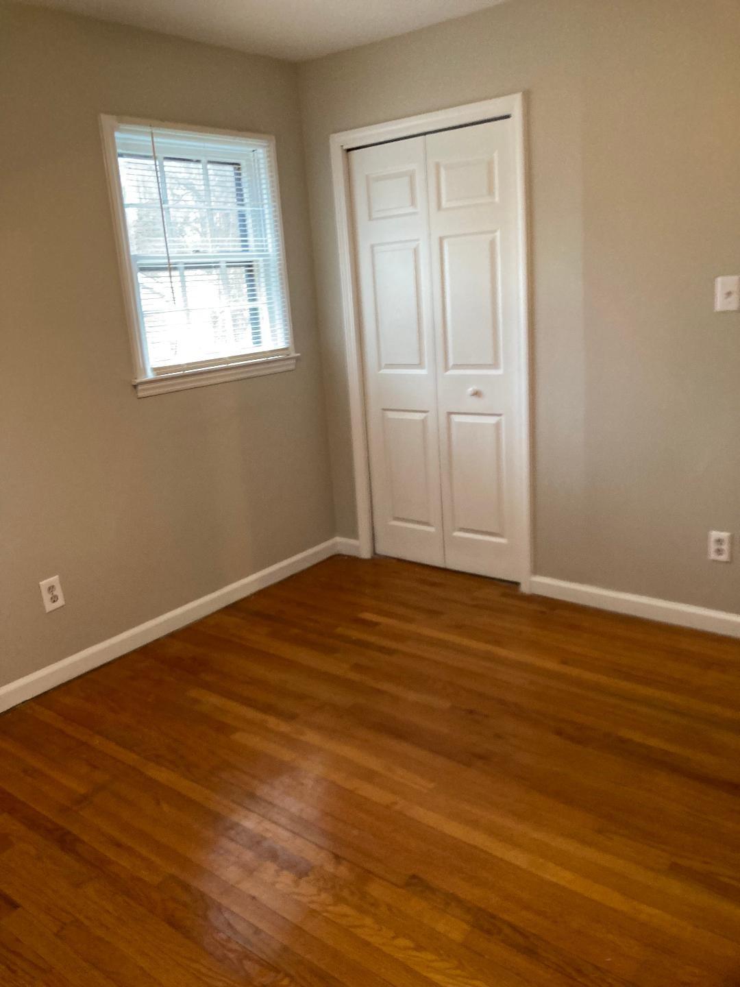 7530 Riding Trail Road Charlotte, NC 28212 - Photo 14 of 20 a view of an empty room with wooden floor and a window