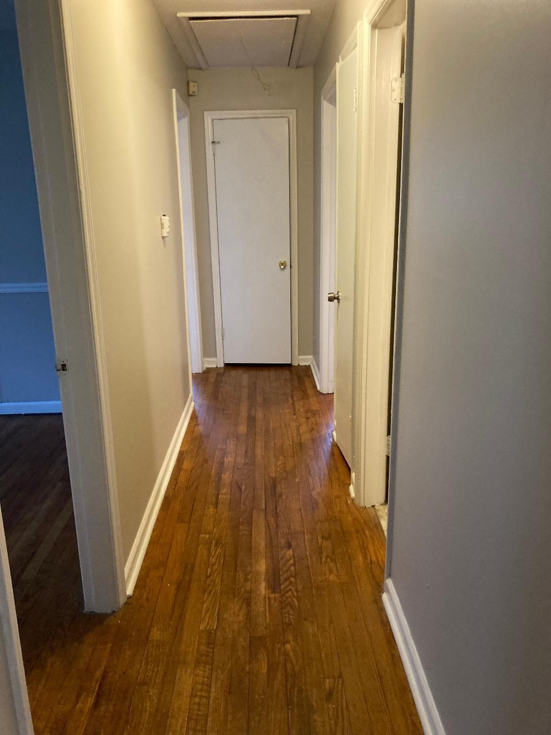 7530 Riding Trail Road Charlotte, NC 28212 - Photo 4 of 20 a view of a hallway with wooden floor and a bathroom