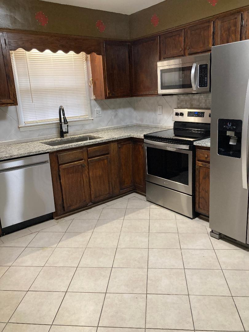 7530 Riding Trail Road Charlotte, NC 28212 - Photo 8 of 20 a kitchen with stainless steel appliances a sink a stove top oven a counter space and cabinets