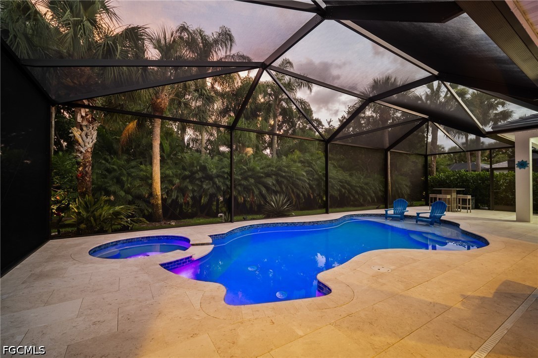 9042 Bronco Court Naples, FL 34113 - Photo 2 of 50 a view of swimming pool with patio
