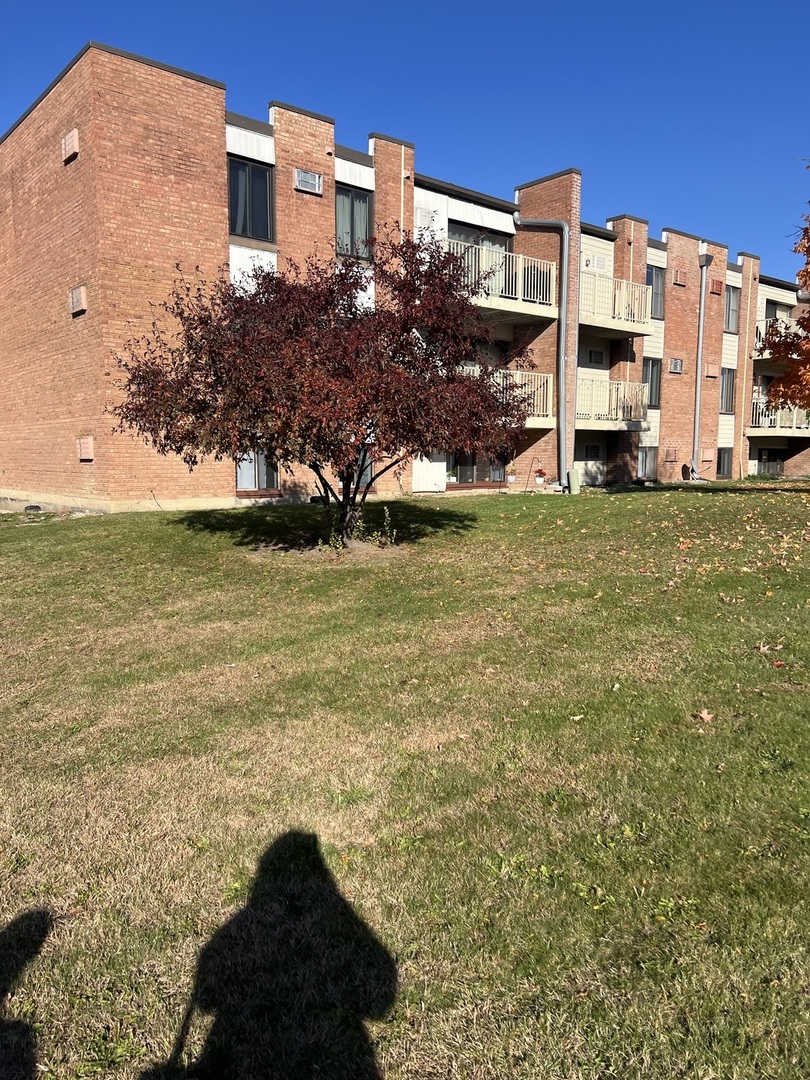 a front view of building with yard