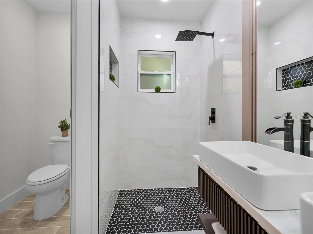 11790 Orange Road Ocklawaha, FL 32179 - Photo 11 of 21 a bathroom with a sink a toilet and shower