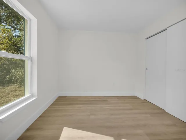 a bathroom with a granite countertop sink toilet a mirror and shower