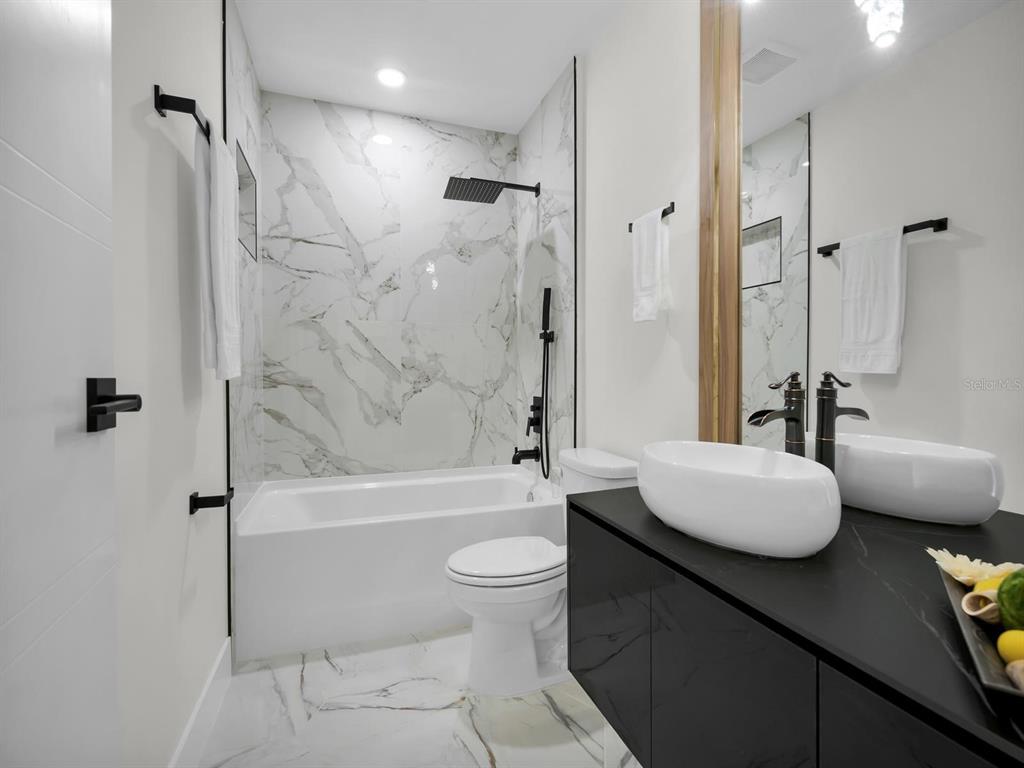 11790 Orange Road Ocklawaha, FL 32179 - Photo 17 of 21 a bathroom with a granite countertop sink toilet a mirror and shower