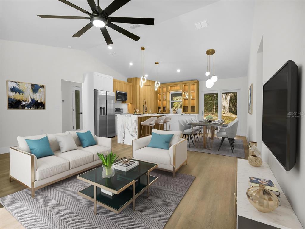 11790 Orange Road Ocklawaha, FL 32179 - Photo 3 of 21 a living room with furniture and a flat screen tv