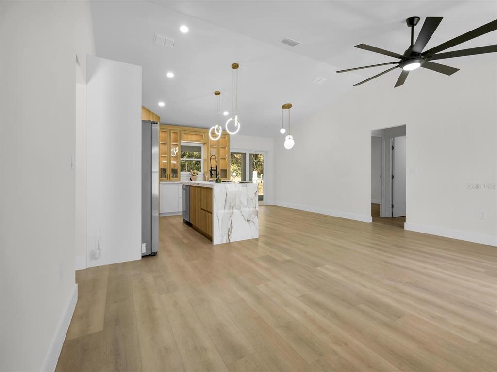 11790 Orange Road Ocklawaha, FL 32179 - Photo 5 of 21 a view of a livingroom with a kitchen
