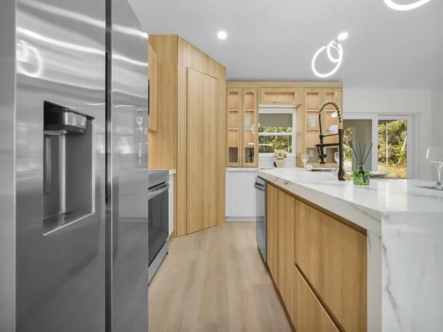 a large kitchen with a table and chairs