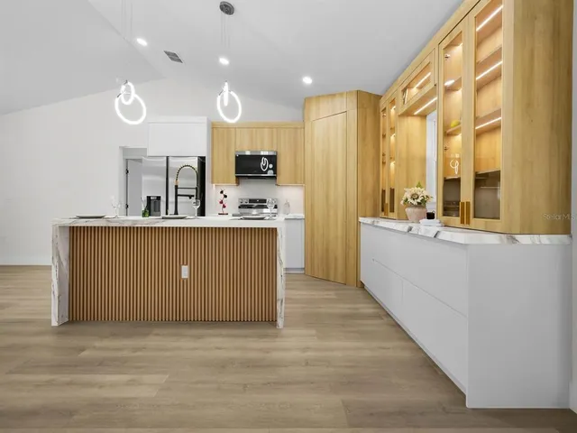 a view of a room with wooden floor
